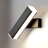 Black LED wall lamp illuminating a bedside reading area