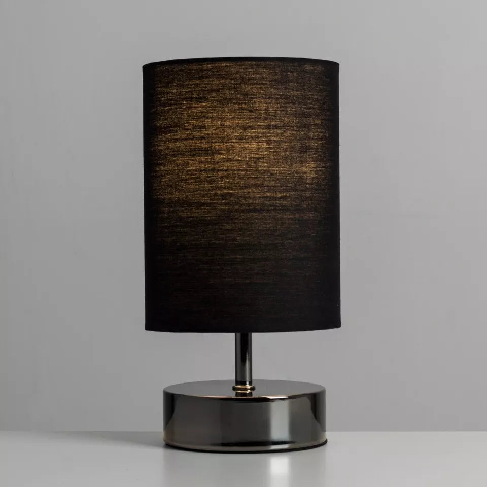 Lamp illuminating a cozy bedroom setting with adjustable brightness.
 Lamp illuminating a cozy bedroom setting with adjustable brightness.