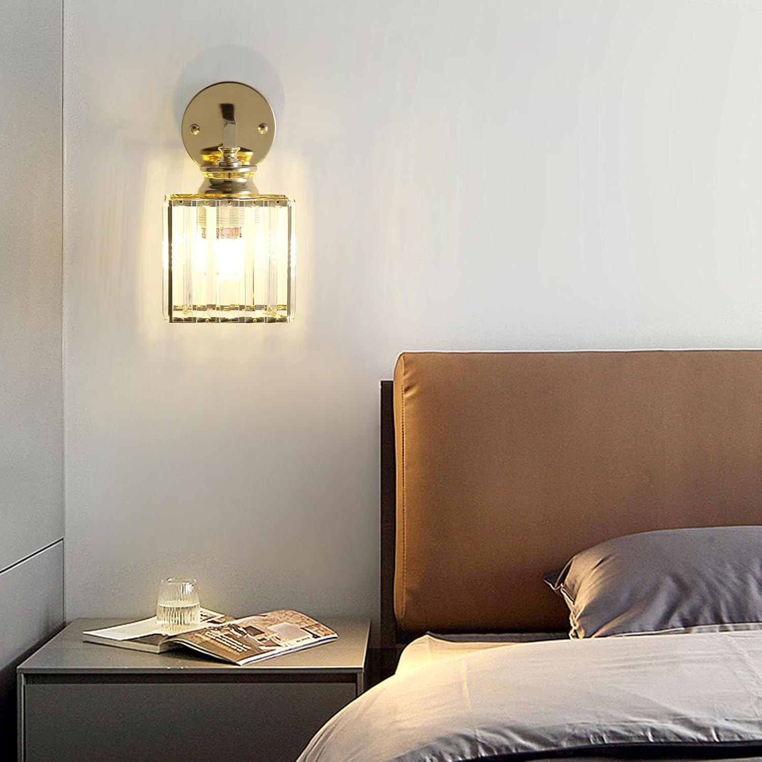 Modern bedroom with a bed, nightstand, and wall sconce.