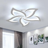 Modern ceiling light fixture in a room with decor elements.