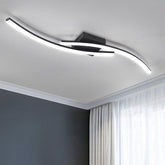 Modern ceiling light fixture in a room with gray walls and white curtains.