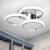 Modern ceiling light fixture in a room with shelves and books.