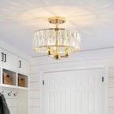 Modern ceiling light fixture in a room with white walls and cabinets.
