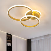 Modern ceiling light fixture with three circular rings on a ceiling.