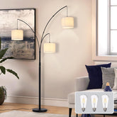 Modern floor lamp with three lampshades in a living room setting, with inset images of light bulbs.