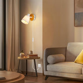 Modern living room with a wall lamp, side table, and sofa.