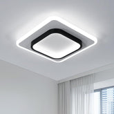 Modern square ceiling light fixture in a room with white walls and a window.