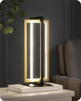 Modern table lamp with a sleek design on a surface next to a sofa.