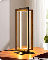 Modern table lamp with wooden frame and LED light on a desk.