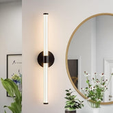 Modern wall sconce with a round mirror and plants in a room setting