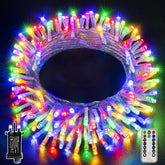 Multicolored LED string lights coiled with remote control on a dark background