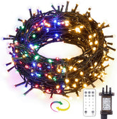 Multicolored string lights with remote control and power adapter on a white background