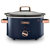 Navy slow cooker with rose gold handles and control knob on a white background