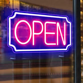 Neon 'OPEN' sign on a glass door