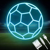 Neon blue soccer ball on a sports field with charging cable and adapter.