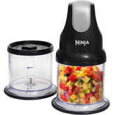 Ninja food chopper with a clear container filled with chopped fruits on a white background