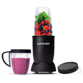Nutribullet blender with a glass of smoothie and ingredients on a white background