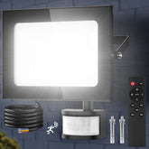 Outdoor security light system with sensor, cable, and remote control on a dark background