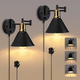Pair of black and gold wall sconces on a neutral background