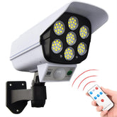 Security camera with LED lights and remote control on a white background