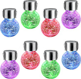 Set of colorful solar glass ball lights on a white background