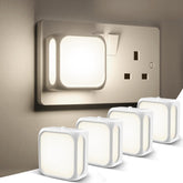 Set of night lights in front of a wall socket on a neutral background