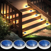 Solar-powered deck lights on wooden steps with four additional lights displayed below.