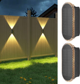 Solar-powered outdoor lights illuminating a fence at night.