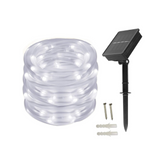 Solar LED string light set with clear cable, solar panel, and stakes on a white background