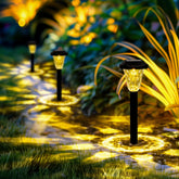 Solar garden lights illuminating a pathway in a garden