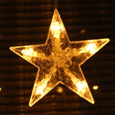 Star-shaped LED light with warm glow on a dark background