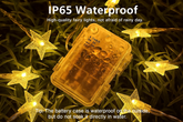 Star-shaped fairy lights with waterproof packaging on grass, featuring text about IP65 waterproof rating.