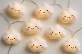 String of cloud-shaped lights with smiling faces on a light background