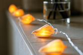 String of glowing shell-shaped lights on a surface with a blurred background