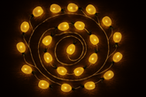 String of lights arranged in a spiral pattern on a dark background