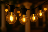 String of lit light bulbs against a blurred background