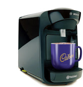 Tassimo coffee machine with a Cadbury branded mug on a white background