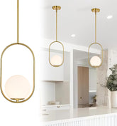 Three gold pendant lights with glass shades in a modern interior setting.