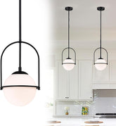 Three pendant lights hanging above a kitchen counter with white cabinets and a backsplash.
