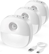 Three white motion sensor lights with a USB cable on a white background