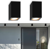 Two black square ceiling lights on a white ceiling with a modern interior setting.