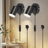 Two black wall lights with pull cords on a neutral background