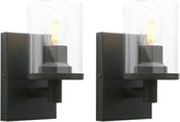 Two black wall sconces with glass shades on a white background
