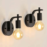 Two black wall sconces with illuminated bulbs on a neutral background