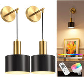 Two gold and black wall sconces with a remote control and smart light bulb on a white background.