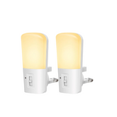 Two night lights with yellow bulbs on a white background