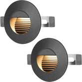 Two round metallic light fixtures with gold interior on a white background