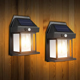 Two solar-powered outdoor wall lights on a wooden background