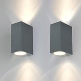 Two square wall lights on a white wall