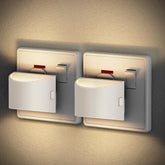 Two wall-mounted night lights on a textured wall.